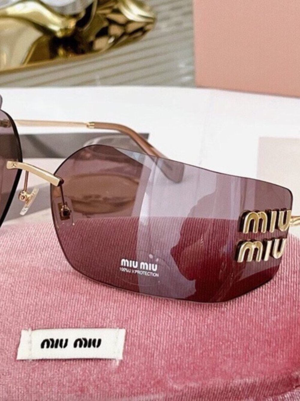 Miu Miu Gold Sunglasses with Purple Lenses